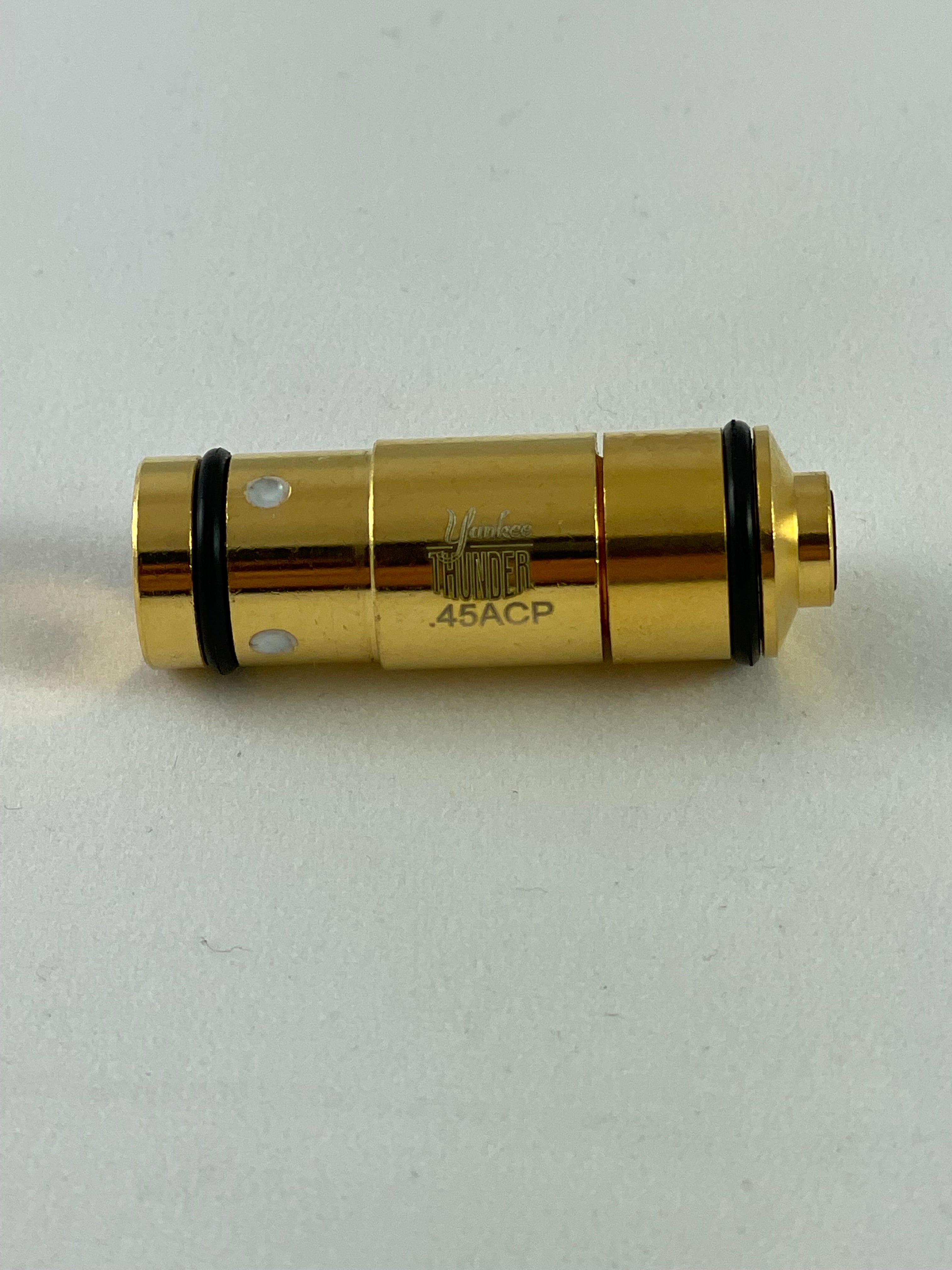 A close-up photograph of a golden .45 Laser Cartridge by Yankee Thunder with the text 